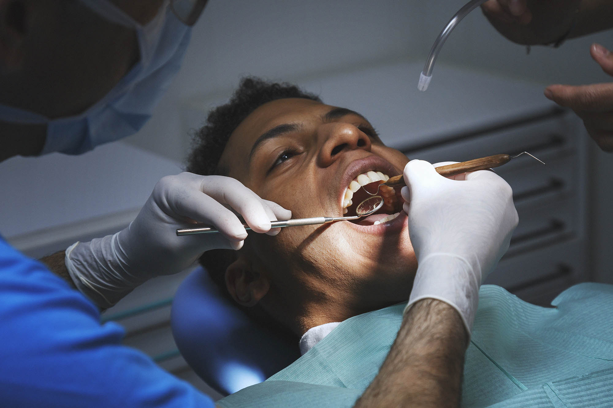 Doctor checking teeth of black man